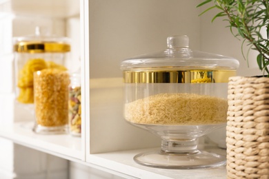 Products in modern kitchen glass containers on shelving unit