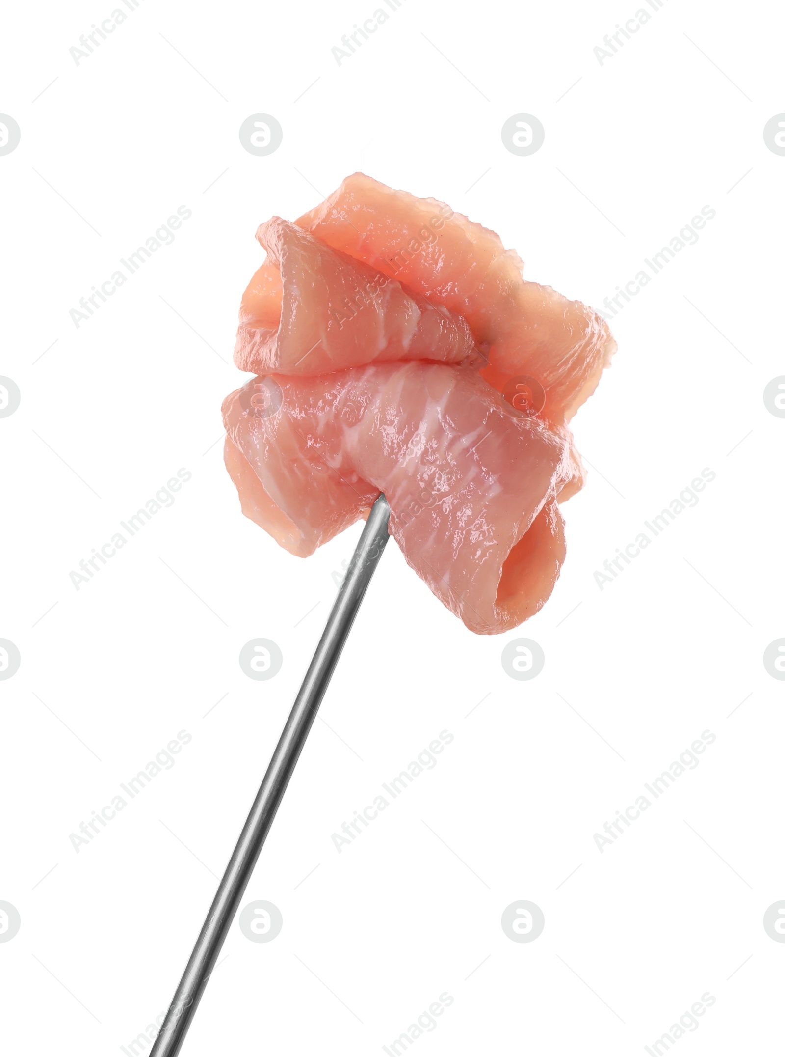 Photo of Fondue fork with pieces of raw meat isolated on white