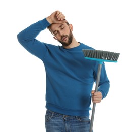 Photo of Tired man with broom on white background