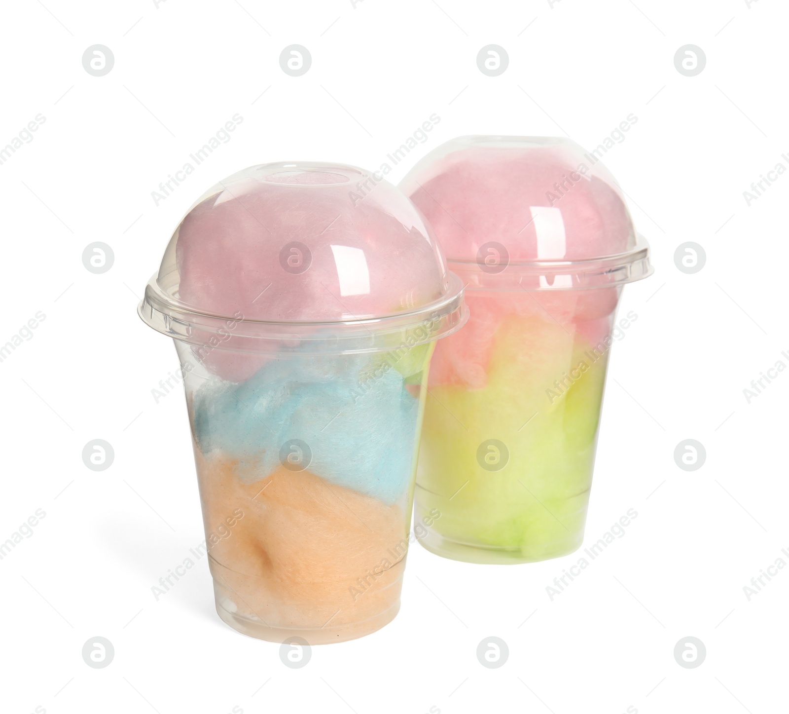 Photo of Plastic cups with tasty cotton candies on white background