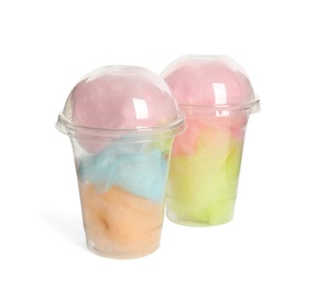 Photo of Plastic cups with tasty cotton candies on white background