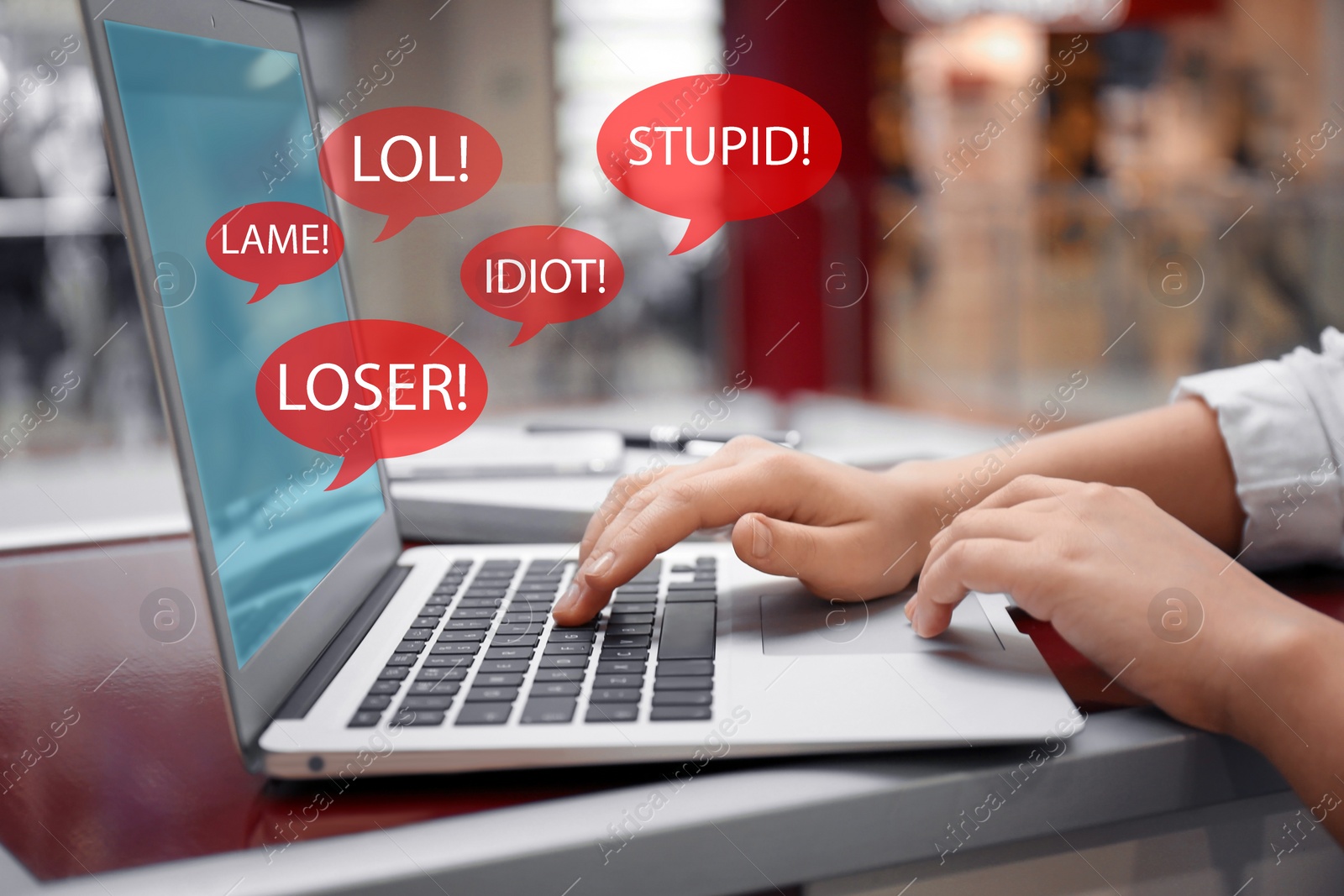 Image of Young woman using laptop at table, closeup. Cyber bullying