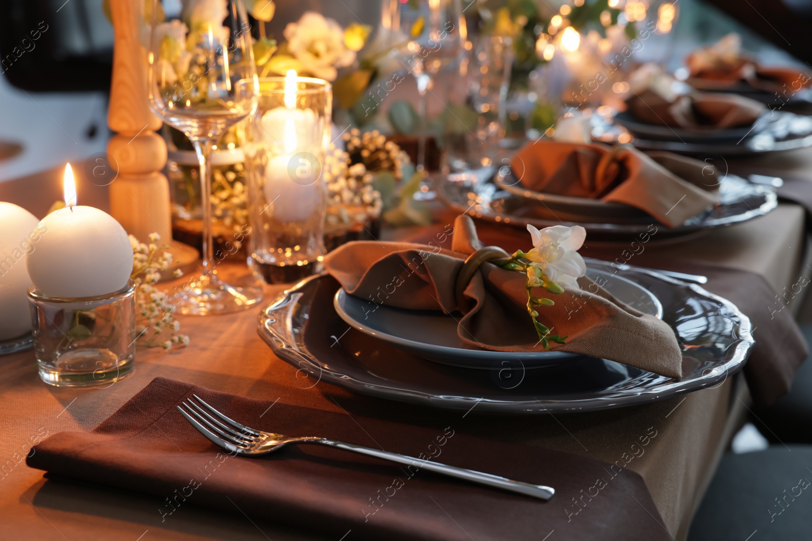 Photo of Elegant table setting with beautiful floral decor and burning candles