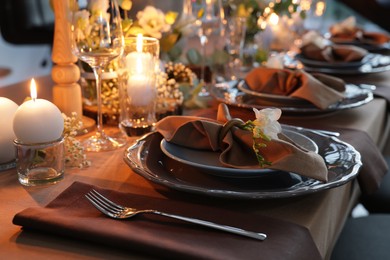 Elegant table setting with beautiful floral decor and burning candles