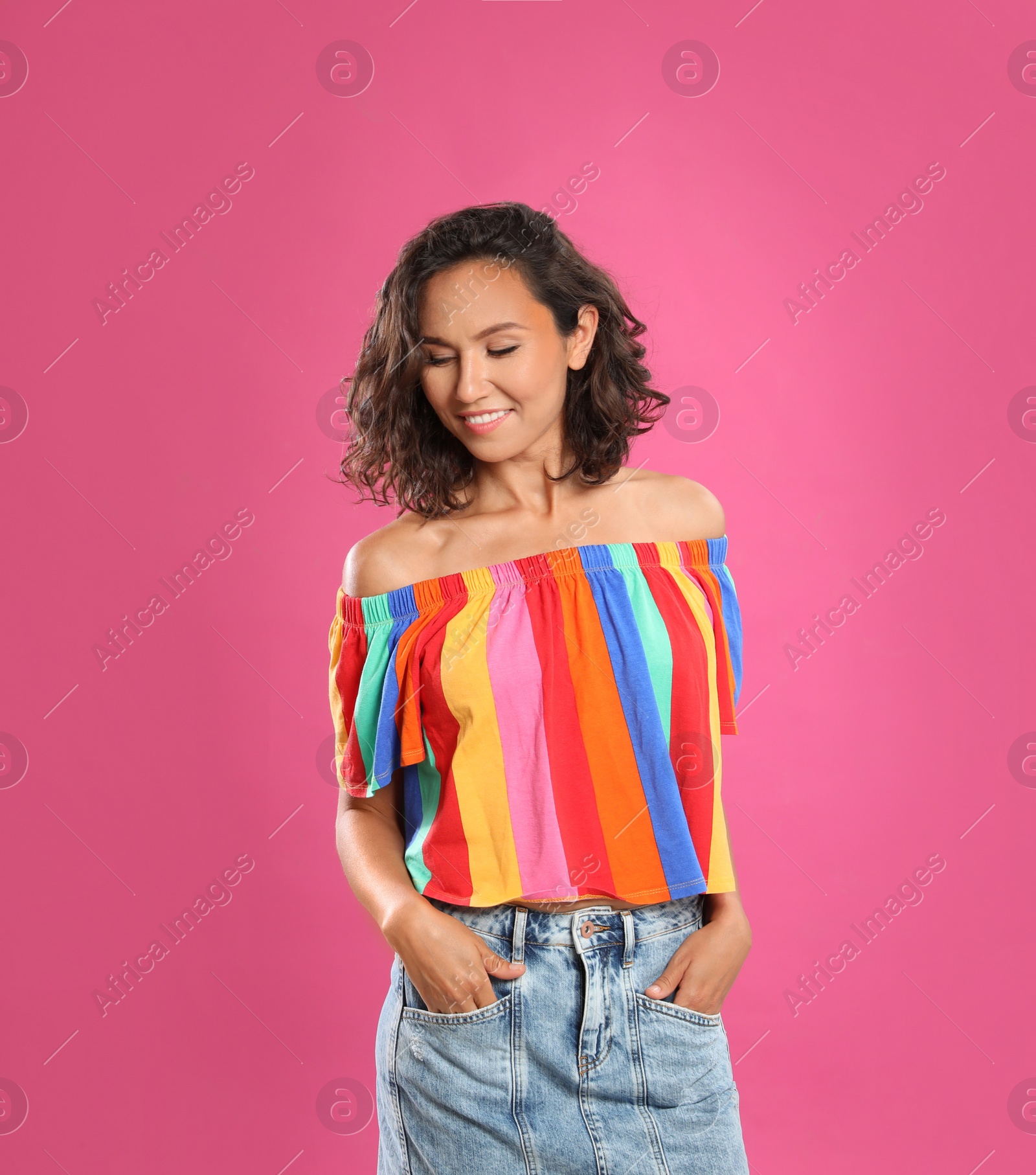 Photo of Happy young woman in casual outfit on pink background