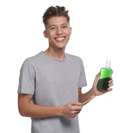 Young man with mouthwash on white background