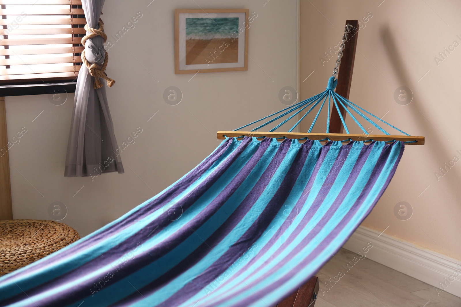 Photo of Comfortable blue hammock in stylish room. Interior design