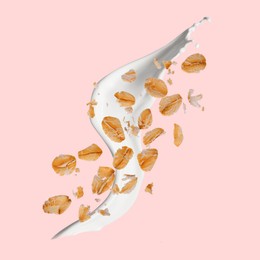 Image of Rolled oats and milk splash on pink background