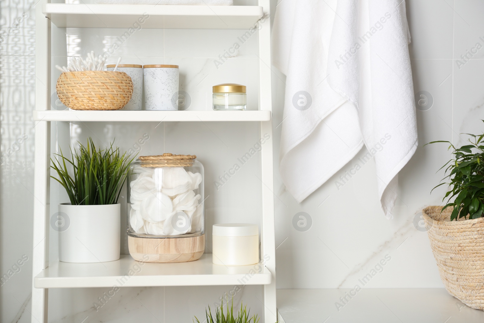 Photo of Shelving unit with toiletries in bathroom interior