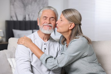 Photo of Senior woman kissing her beloved man at home