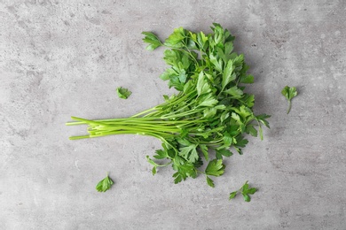 Photo of Fresh green parsley on grey background, top view