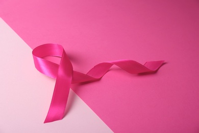 Pink ribbon on color background. Breast cancer awareness concept