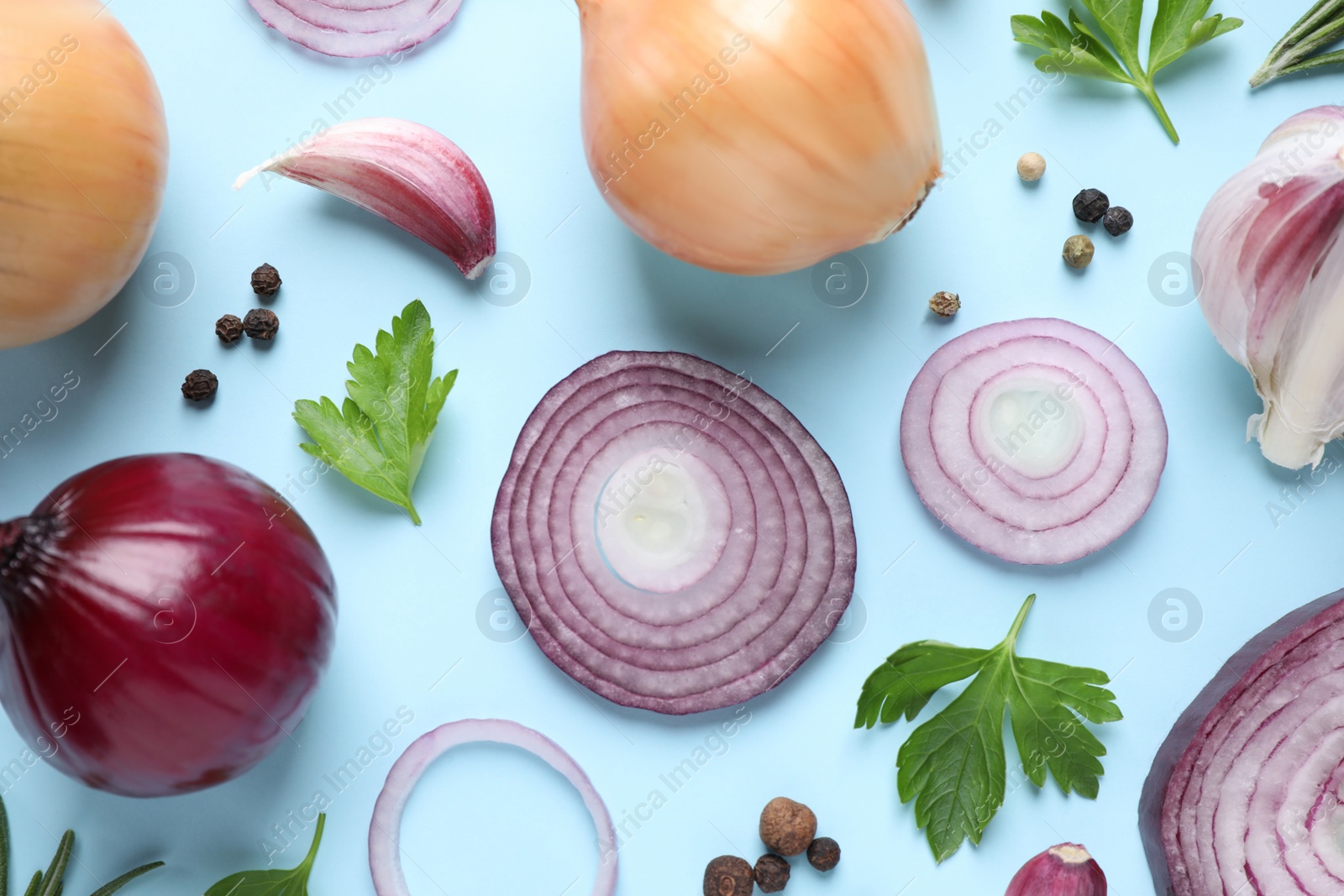 Photo of Flat lay composition with onion and spices on light blue background