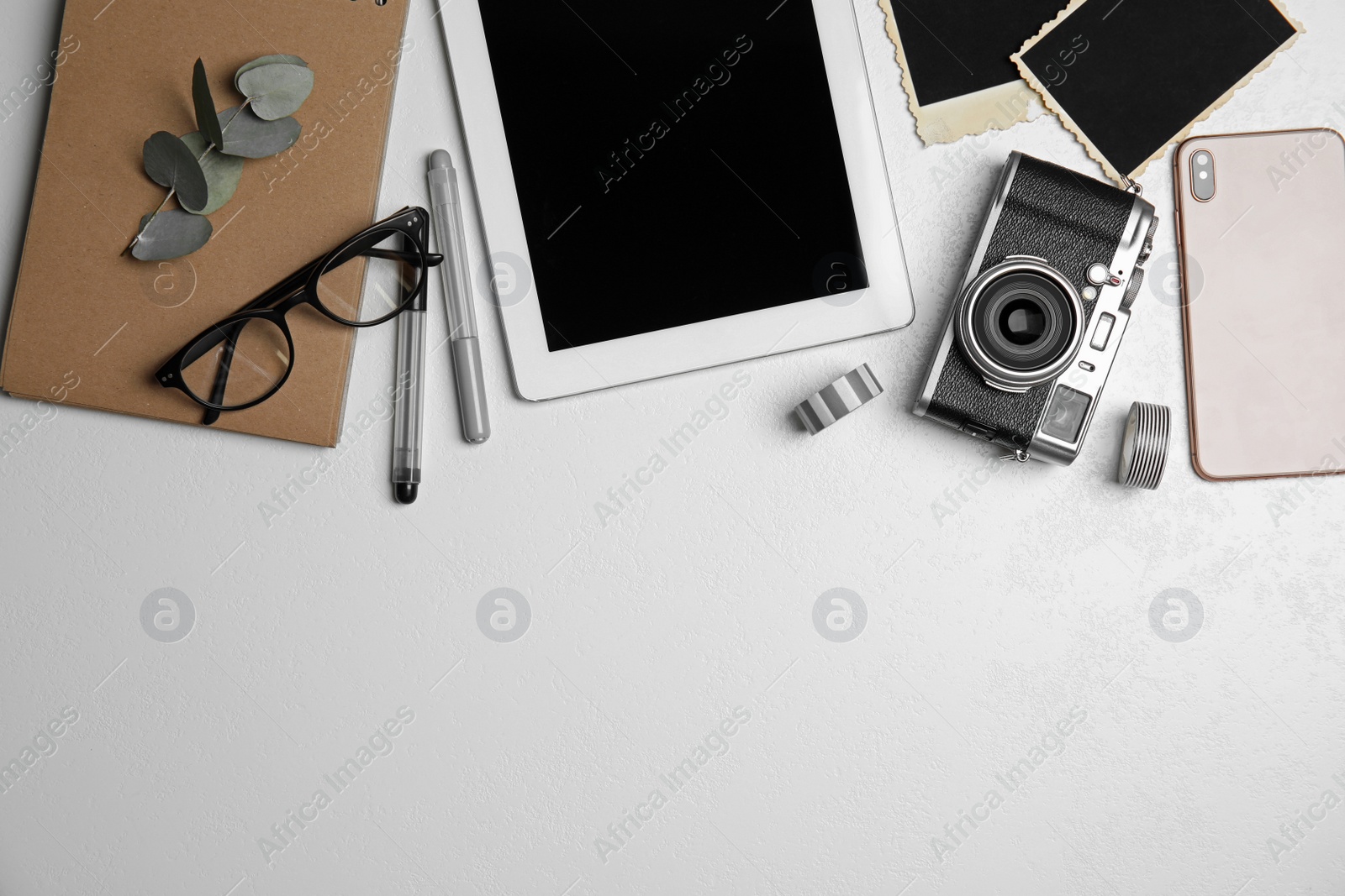 Photo of Flat lay composition with vintage camera and tablet on white table, space for text. Designer's workplace