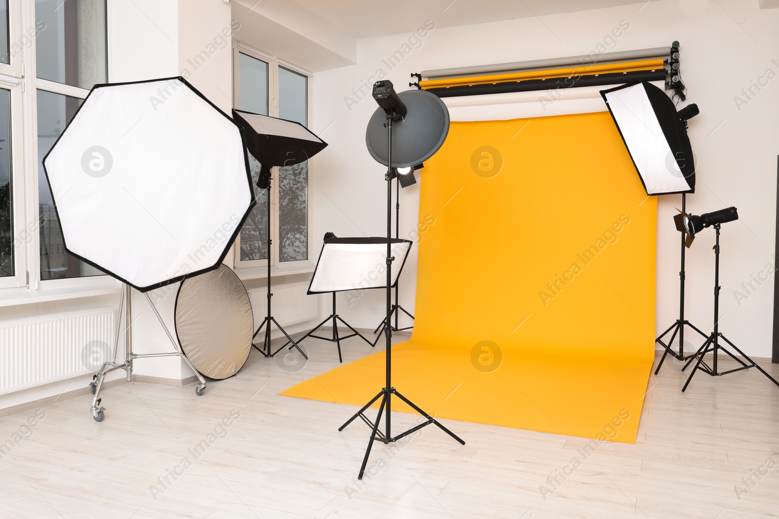 Photo of Interior of modern photo studio with professional lighting equipment