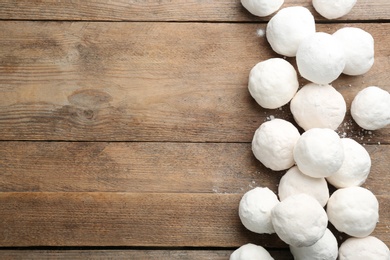 Photo of Snowballs on wooden background, flat lay. Space for text