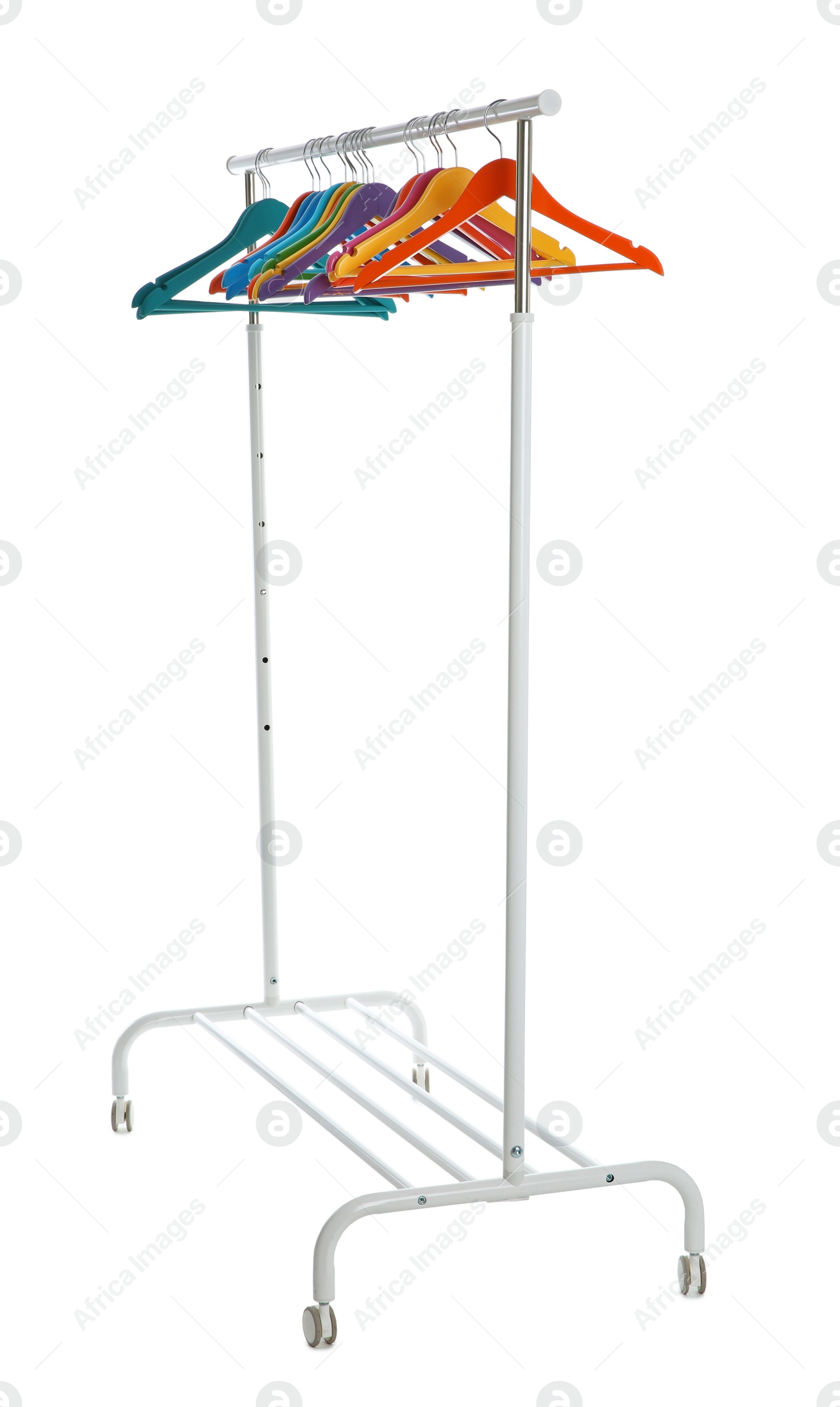 Photo of Wardrobe rack with different color hangers isolated on white