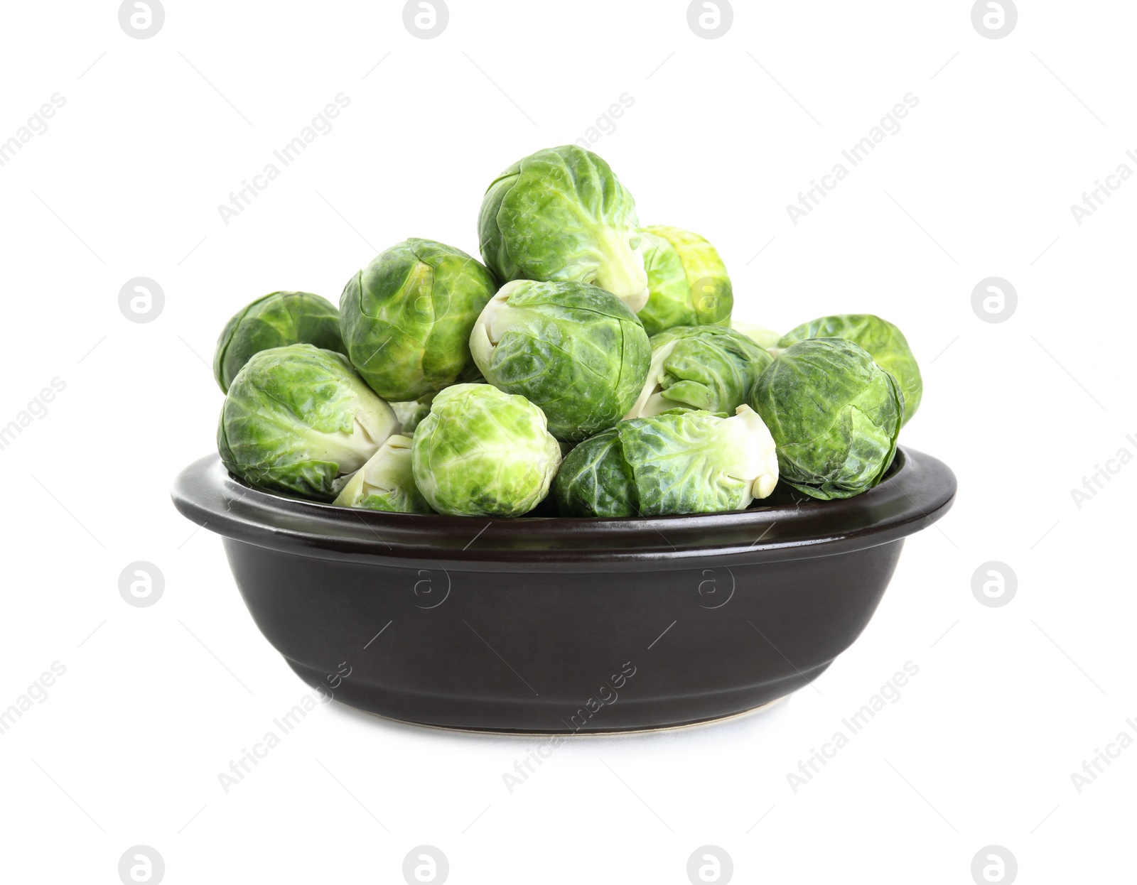 Photo of Fresh Brussels sprouts in bowl isolated on white