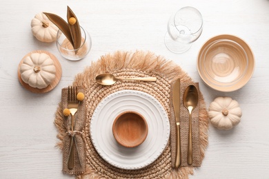 Photo of Autumn table setting with pumpkins on white wooden background, flat lay