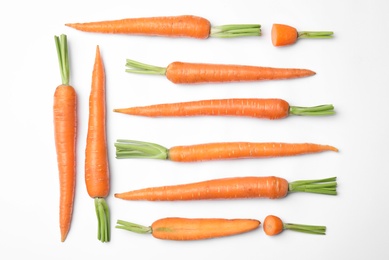 Photo of Ripe fresh carrots on white background