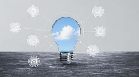 Image of Cloud technology concept. Light bulb with sky and different icons