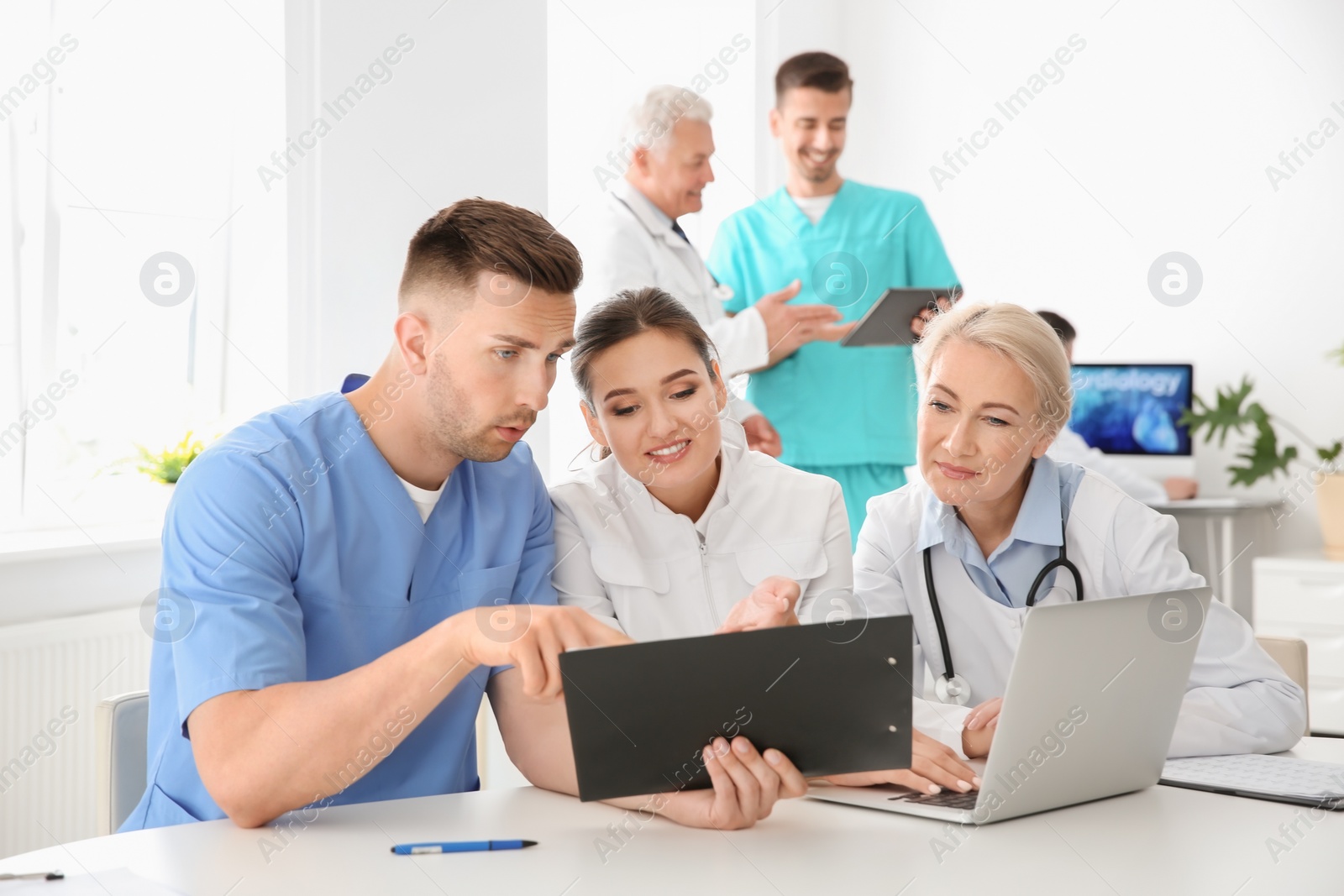 Photo of Group of doctors attending meeting in clinic. Cardiology conference