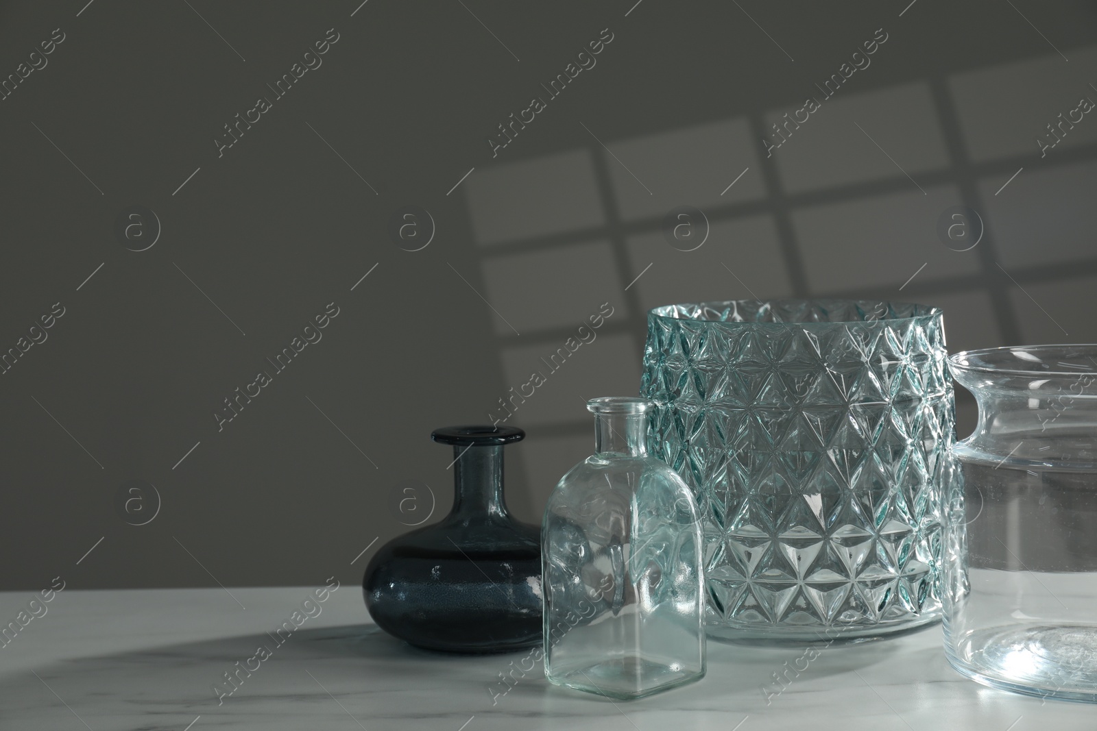 Photo of Different stylish vases on white marble table, space for text