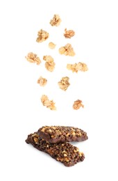Image of Tasty protein bars and granola falling on white background