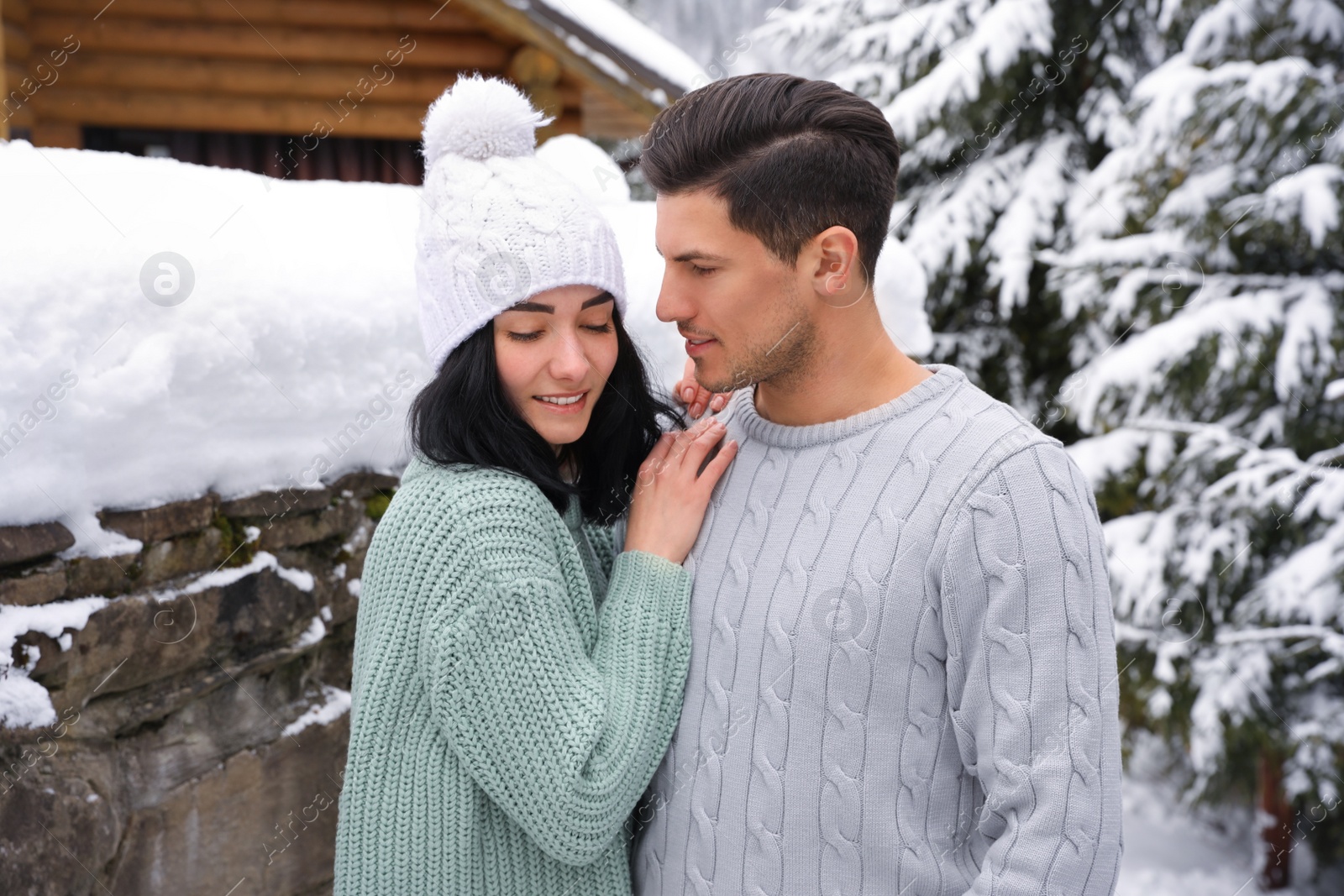 Photo of Happy couple in warm sweaters outdoors on winter day