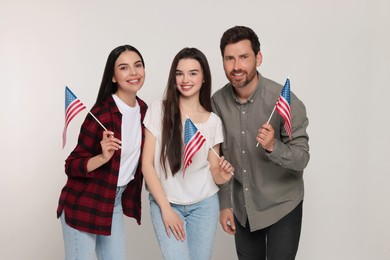 Photo of 4th of July - Independence Day of USA. Happy family with American flags on white background
