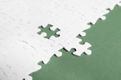 Photo of Blank white puzzle pieces on grey background