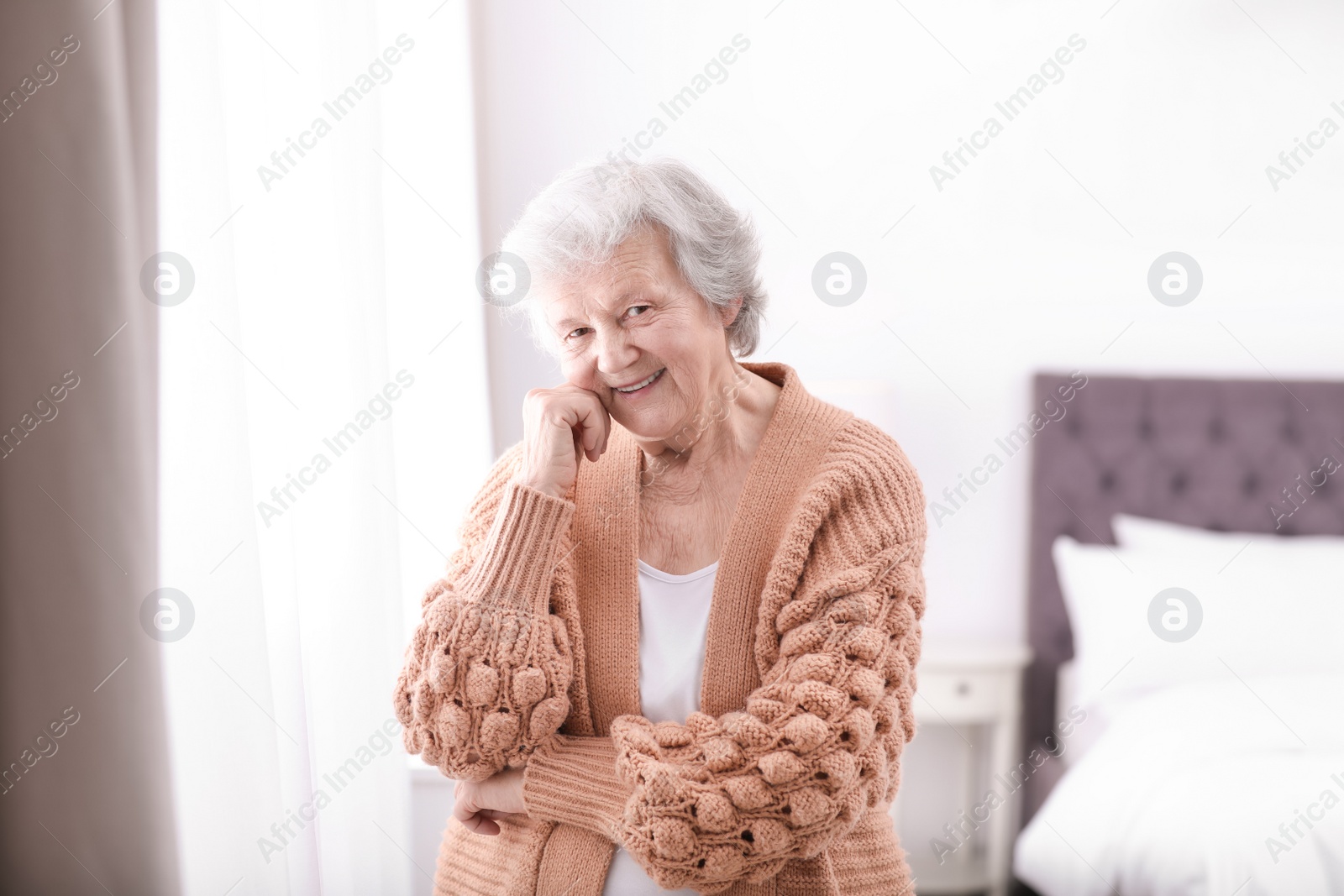 Photo of Portrait of beautiful grandmother in sweater at home