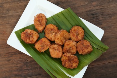 Photo of Delicious fried bananas on wooden table, top view