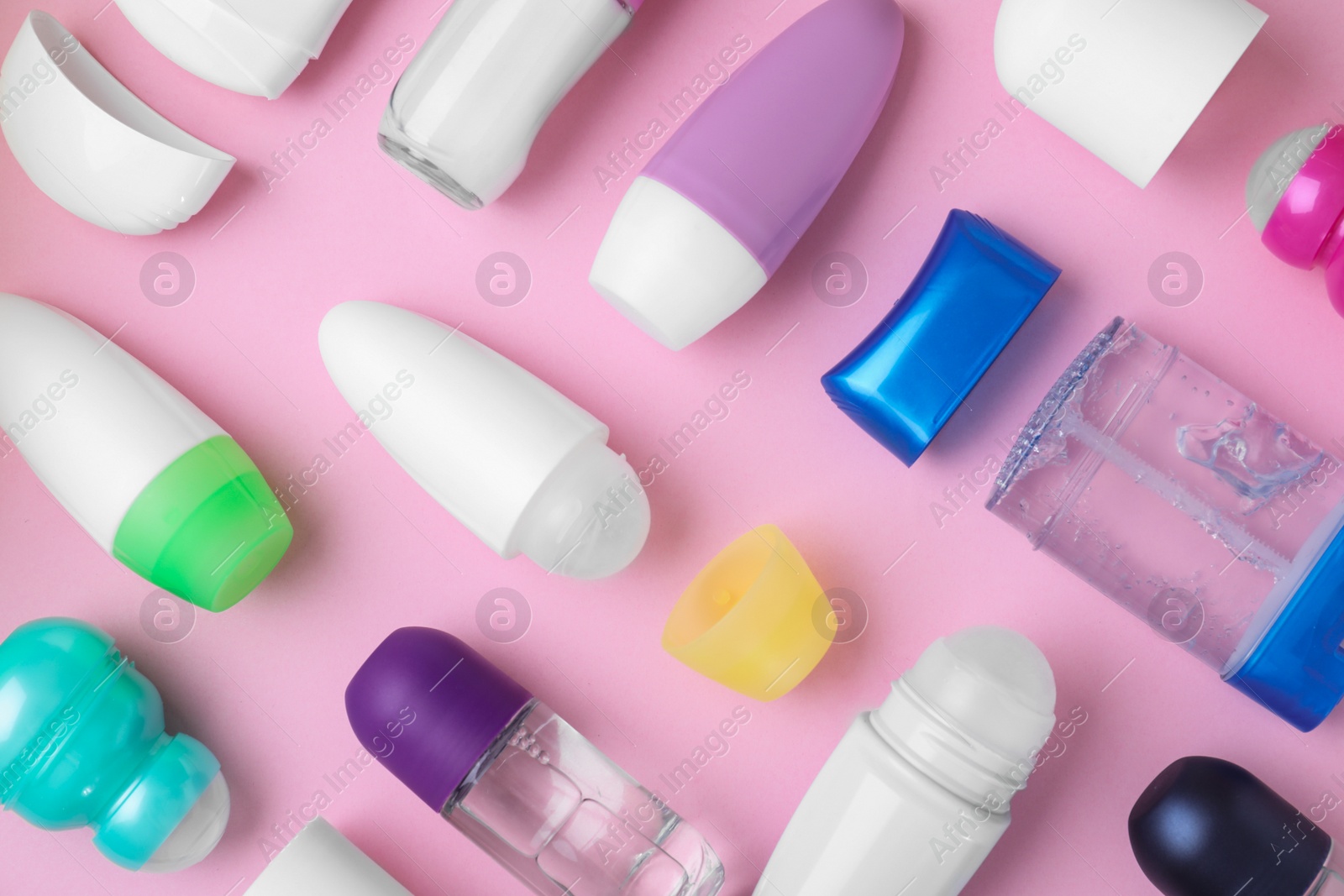 Photo of Flat lay composition with different natural deodorants on pink background