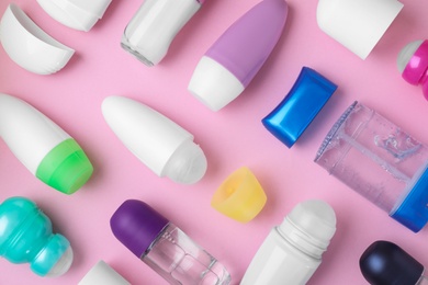 Photo of Flat lay composition with different natural deodorants on pink background