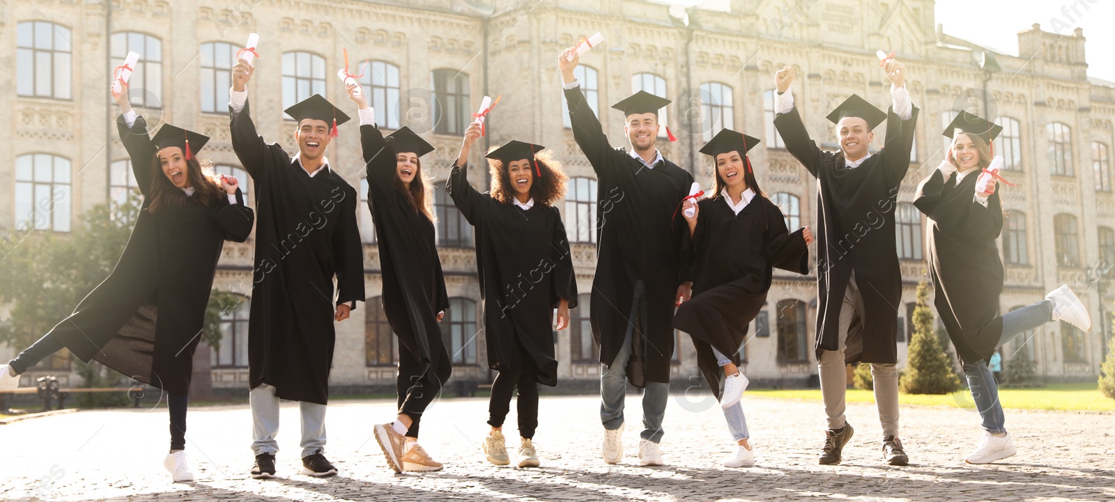 Image of Happy students with diplomas near campus. Banner design