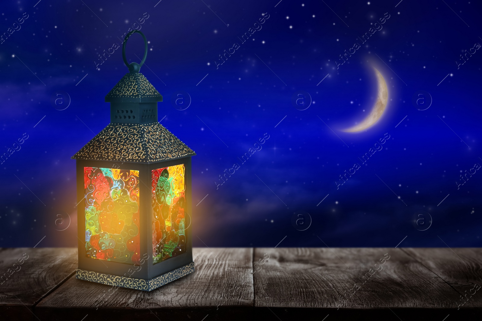 Image of Beautiful decorative Arabic lantern on wooden table at night, space for text. Fanous as Ramadan symbol