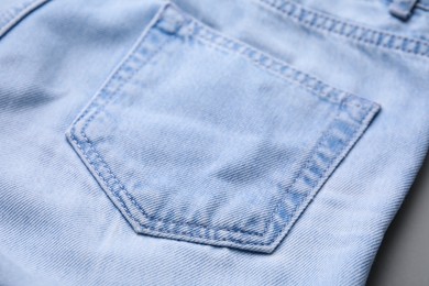 Jeans with pocket on grey background, closeup