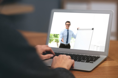 Image of Woman having online video consultation with business trainer at table, closeup