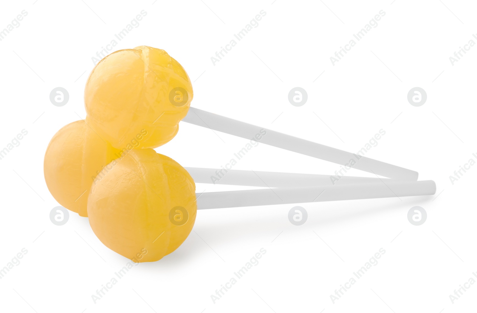 Photo of Many sweet yellow lollipops isolated on white