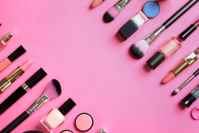 Photo of Flat lay composition with products for decorative makeup on pink background