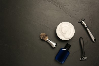 Photo of Set of men's shaving tools on black textured table, flat lay. Space for text