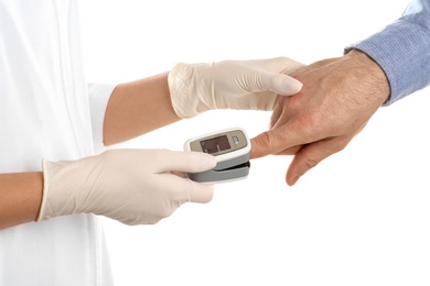 Doctor checking patient's oxygen level with pulse oximeter on white background, closeup
