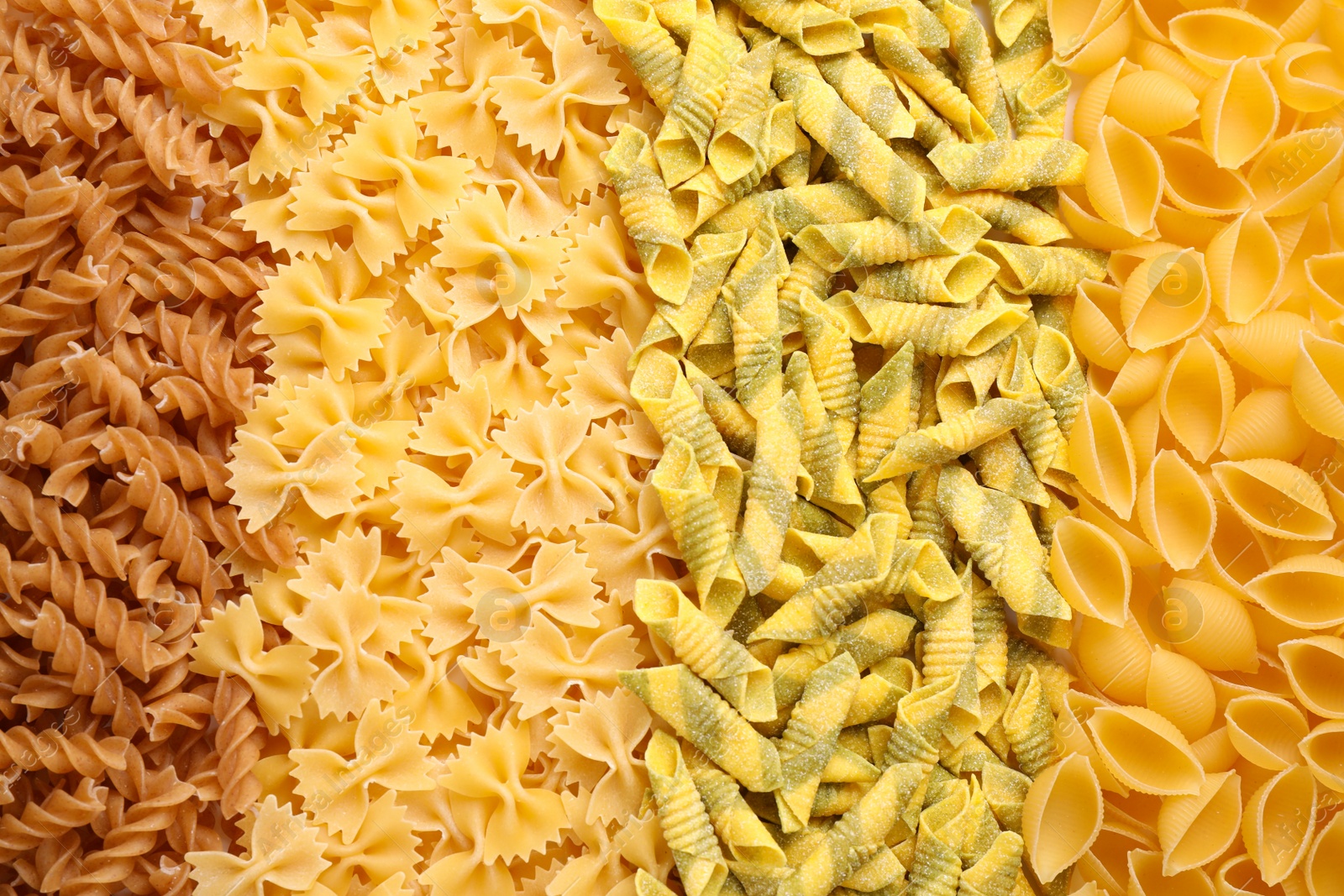 Photo of Different types of pasta as background, top view