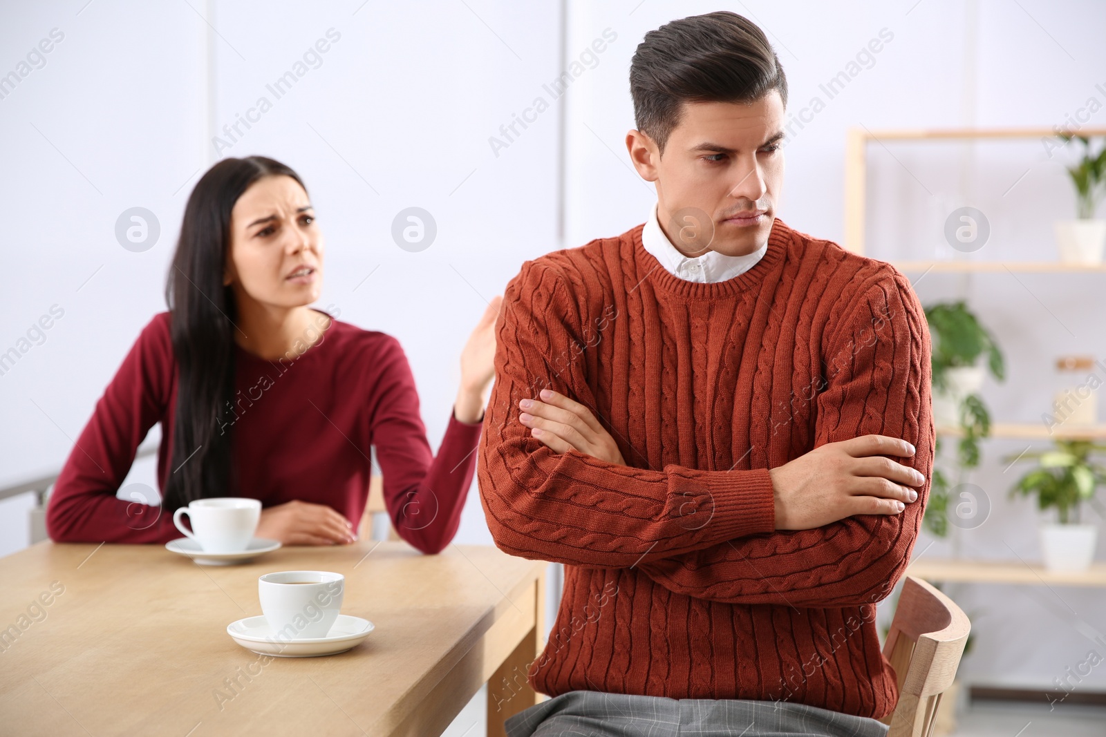 Photo of Couple with relationship problems at table in cafe