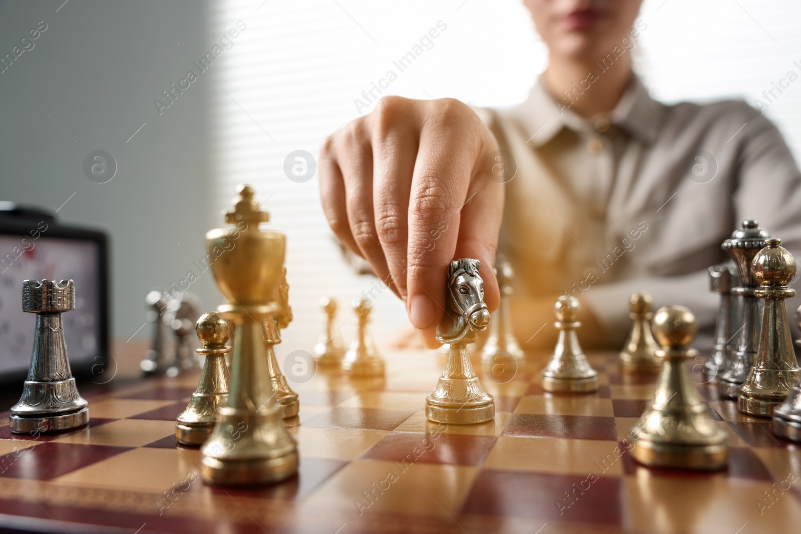 Photo of Woman playing chess during tournament at chessboard, closeup