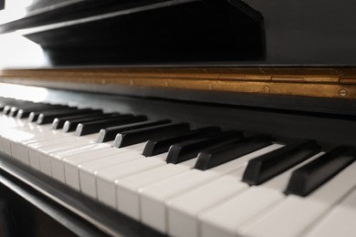 Photo of Modern piano with black and white keys, closeup