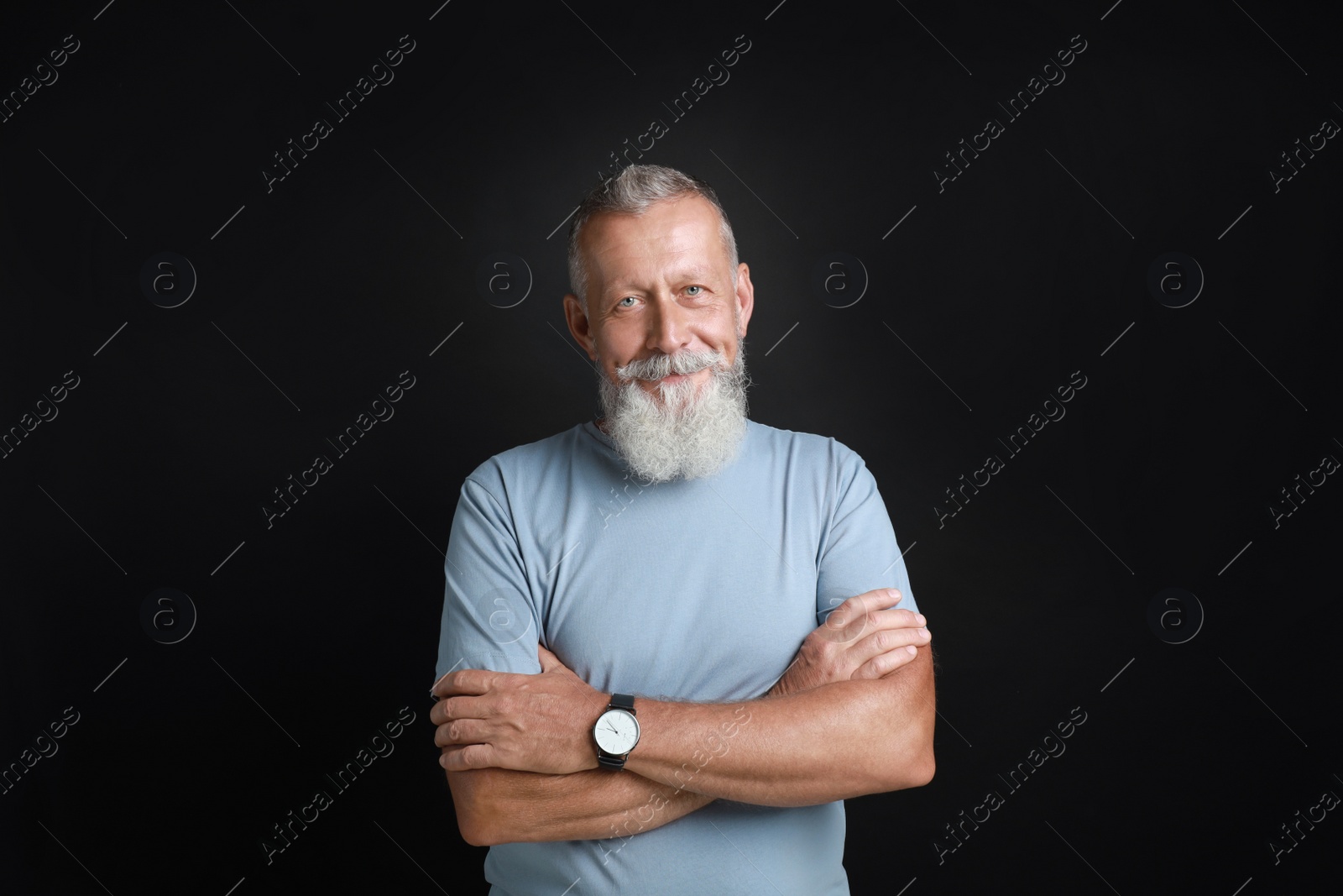 Photo of Portrait of handsome senior man on black background