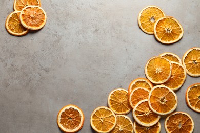 Photo of Dry orange slices on light grey table, flat lay. Space for text