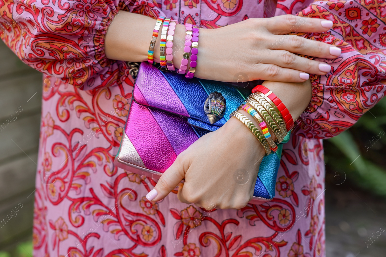 Photo of Woman with stylish purse wearing bracelets outdoors, closeup